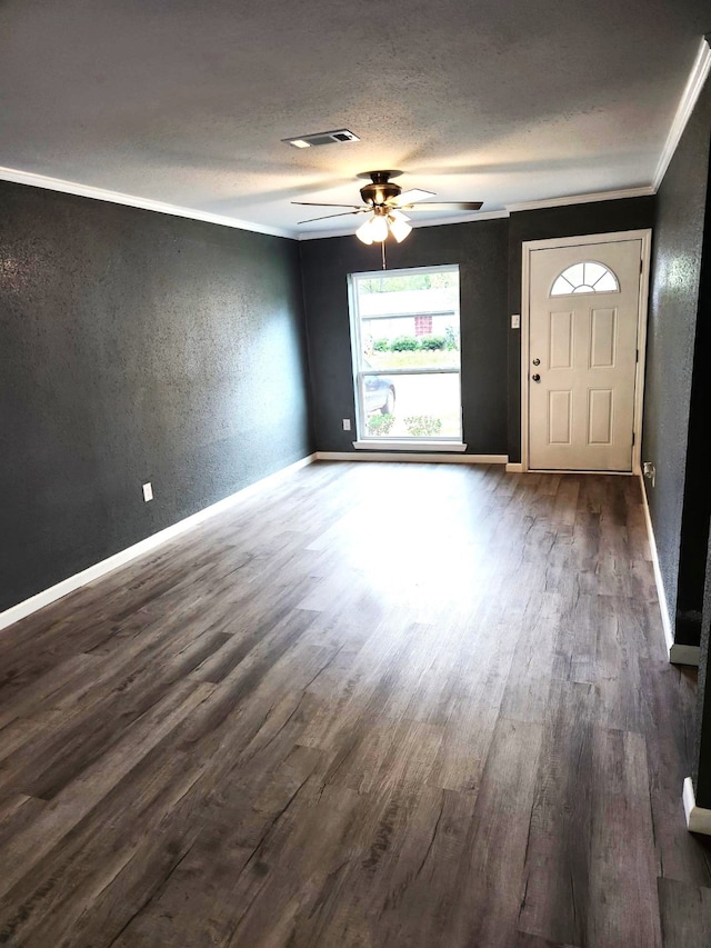 foyer entrance featuring ceiling fan, ornamental molding, and dark hardwood / wood-style flooring