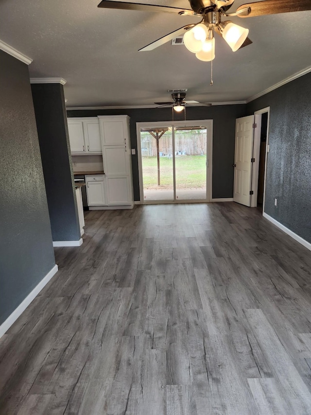 unfurnished living room featuring ornamental molding, wood-type flooring, and ceiling fan