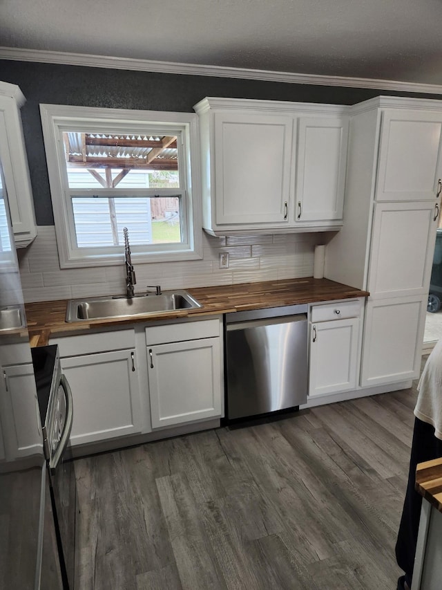 kitchen with sink, wood counters, decorative backsplash, and dishwasher