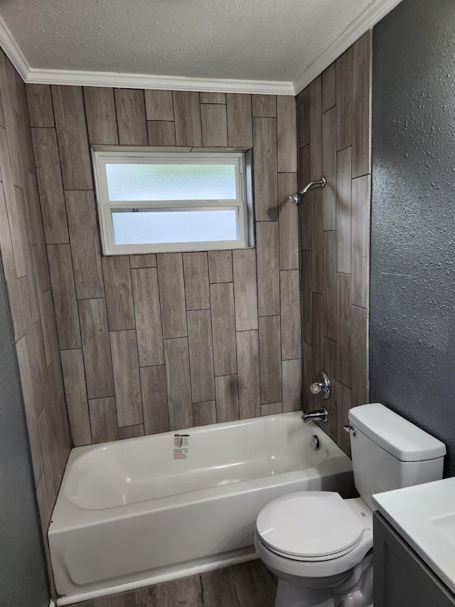 full bathroom with toilet, tiled shower / bath, ornamental molding, vanity, and a textured ceiling