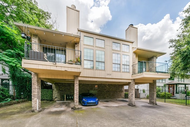 exterior space with a carport and a balcony