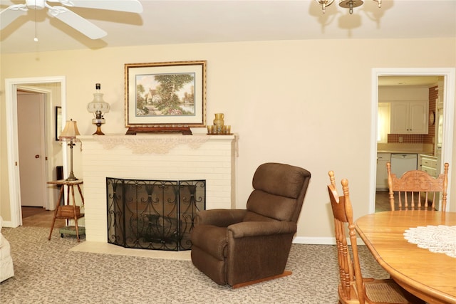 living area with carpet flooring, a fireplace, and ceiling fan