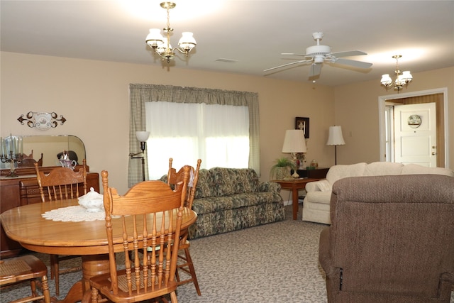 carpeted dining area with ceiling fan with notable chandelier