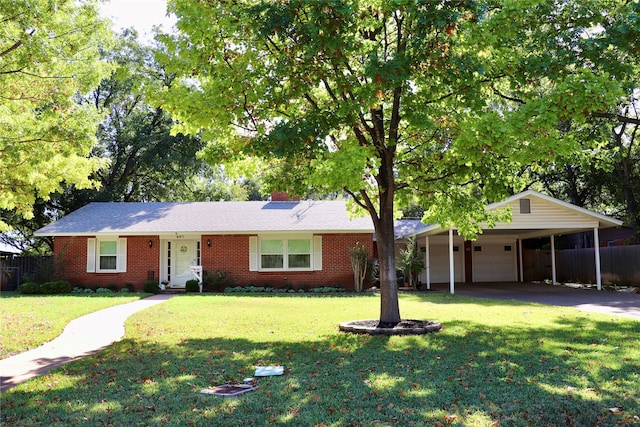 ranch-style house featuring a carport, a front yard, and a garage