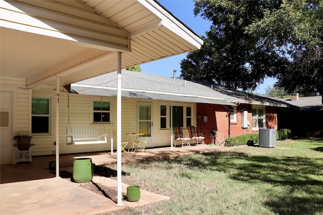 back of house featuring a yard, central air condition unit, and a patio