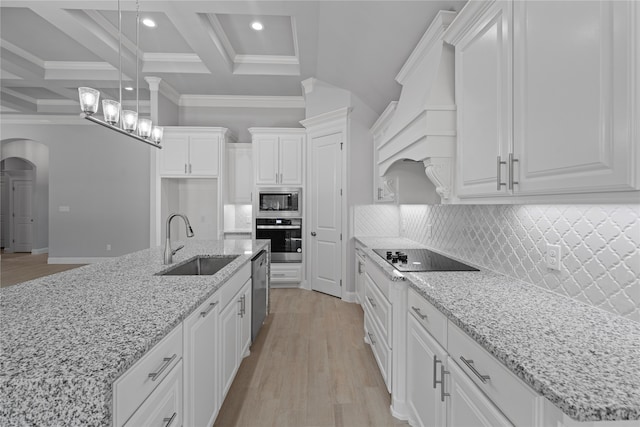 kitchen with beam ceiling, stainless steel appliances, sink, premium range hood, and white cabinetry