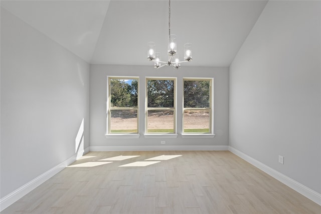 unfurnished dining area with lofted ceiling, light wood-type flooring, and a wealth of natural light