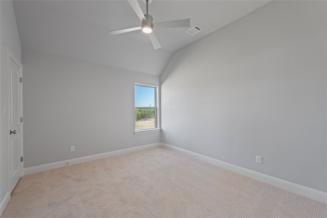 unfurnished room featuring vaulted ceiling, light carpet, and ceiling fan