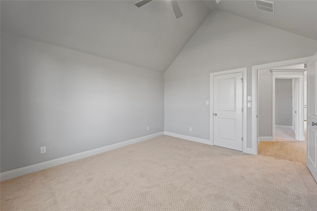 spare room with light carpet, high vaulted ceiling, and ceiling fan