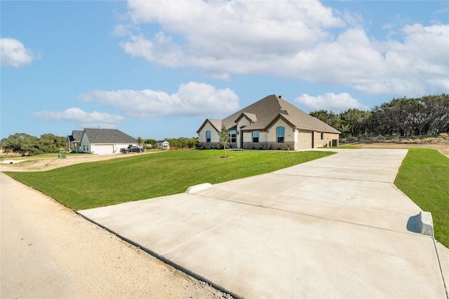 view of front of house featuring a front lawn and a garage