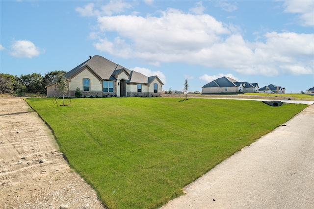 single story home featuring a front yard