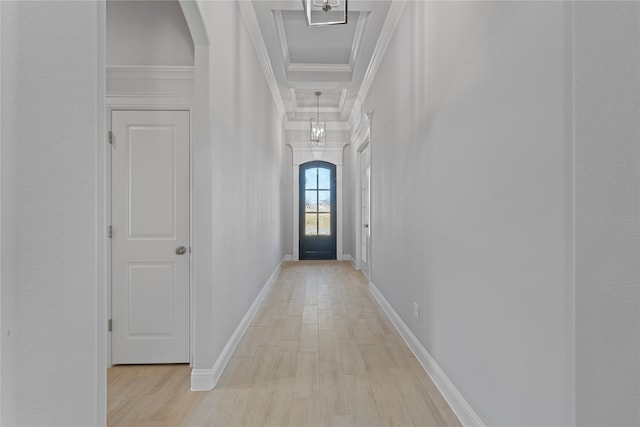 hall with light hardwood / wood-style flooring and ornamental molding