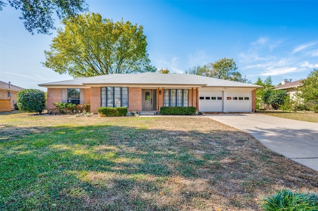 ranch-style house with a garage and a front lawn