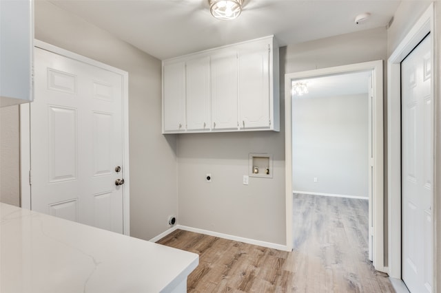 washroom with washer hookup, cabinets, hookup for an electric dryer, and light wood-type flooring