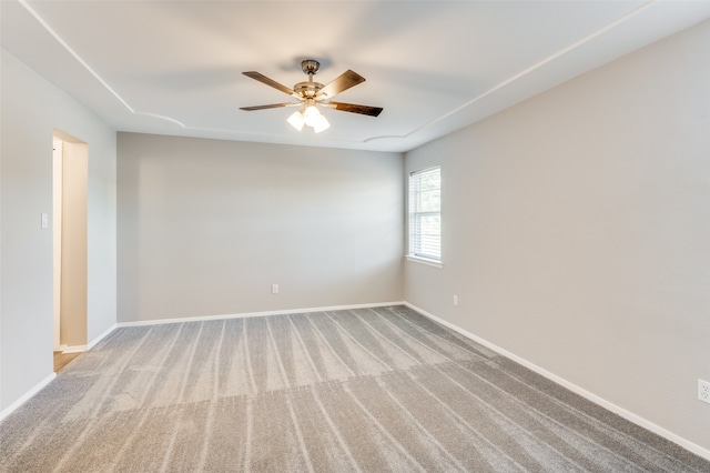 empty room featuring light carpet and ceiling fan