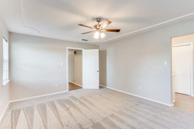 spare room with light carpet and ceiling fan