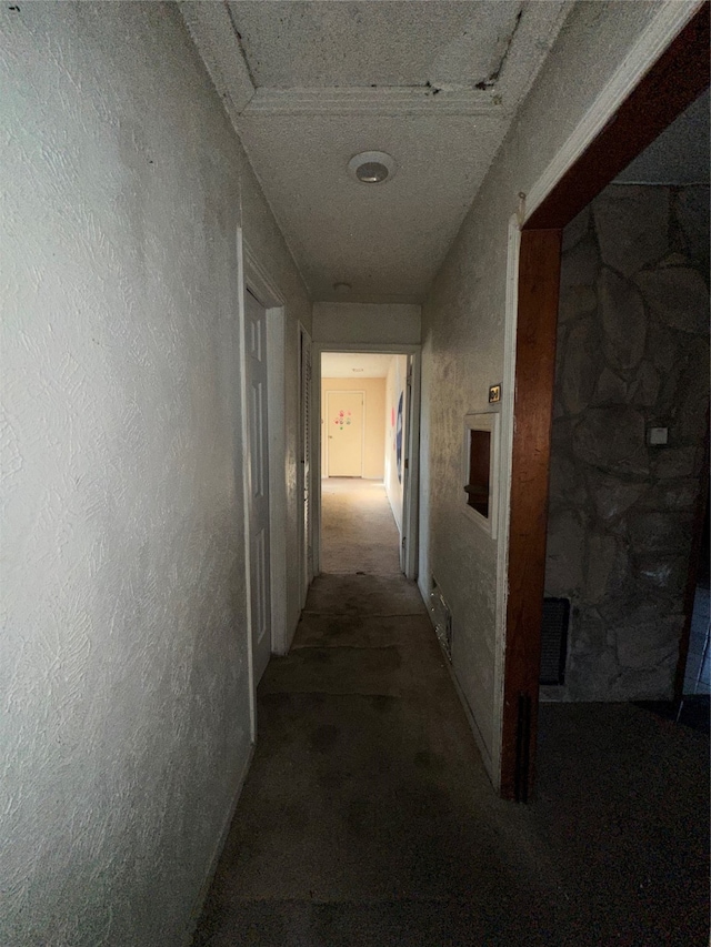 corridor featuring a textured ceiling