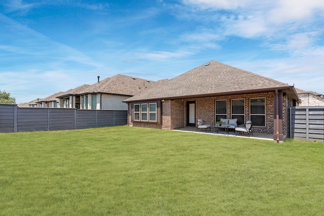 back of property featuring a yard and a patio