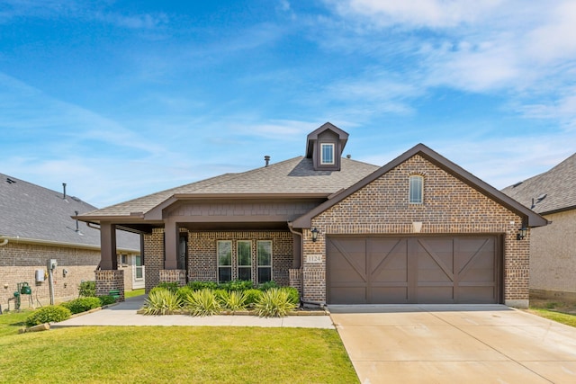 craftsman-style house featuring a front lawn and a garage