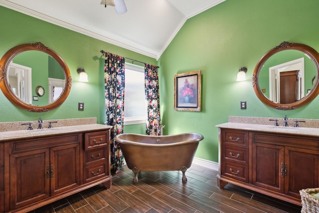 bathroom with lofted ceiling, vanity, crown molding, hardwood / wood-style flooring, and a bathtub