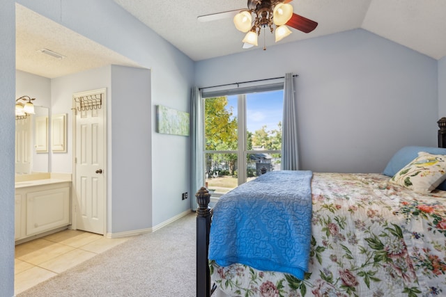 bedroom with ensuite bath, a textured ceiling, ceiling fan, lofted ceiling, and light colored carpet