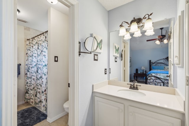 bathroom featuring toilet, vanity, tile patterned floors, and ceiling fan