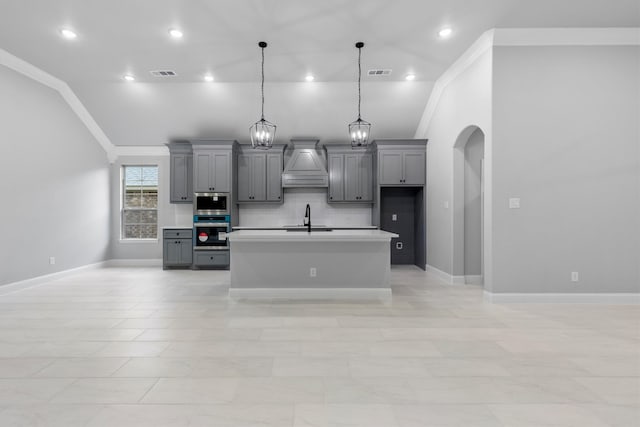 kitchen with gray cabinets, stainless steel appliances, sink, and vaulted ceiling