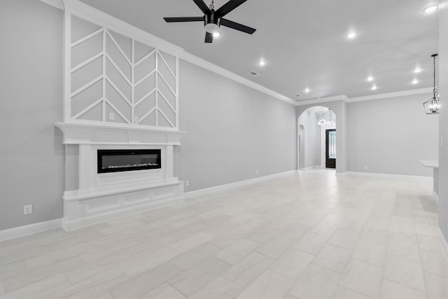 unfurnished living room featuring crown molding and ceiling fan