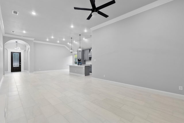 unfurnished living room with crown molding and ceiling fan