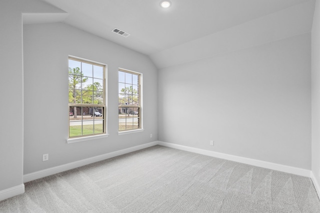 unfurnished room with carpet and vaulted ceiling