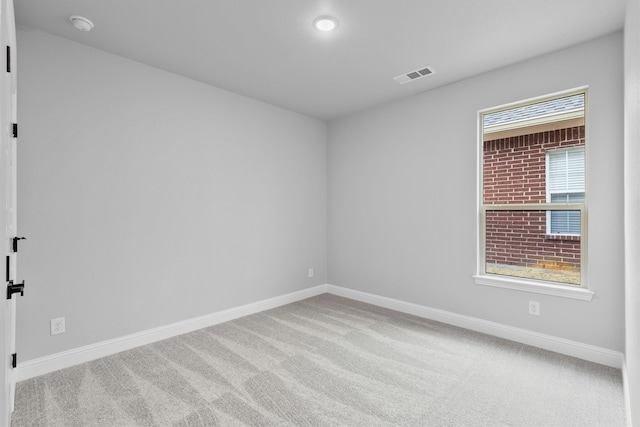 spare room with light carpet