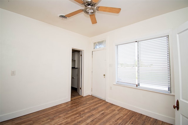 empty room featuring hardwood / wood-style flooring and ceiling fan