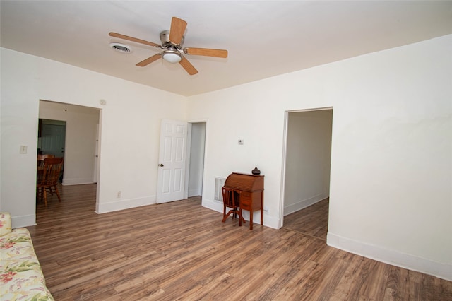 spare room with ceiling fan and dark hardwood / wood-style floors