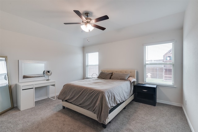 carpeted bedroom featuring multiple windows and ceiling fan