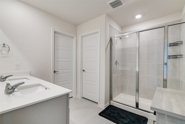 bathroom with vanity, tile patterned floors, and a shower with shower door