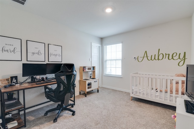 bedroom featuring carpet and a crib