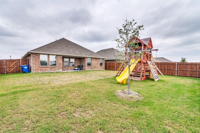 723 Cherish Day Dr, Lavon, TX 75166 - back of property with a playground, brick siding, and a shingled roof