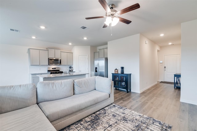 723 Cherish Day Dr, Lavon, TX 75166 - living area with light wood-type flooring, ceiling fan, recessed lighting, and baseboards