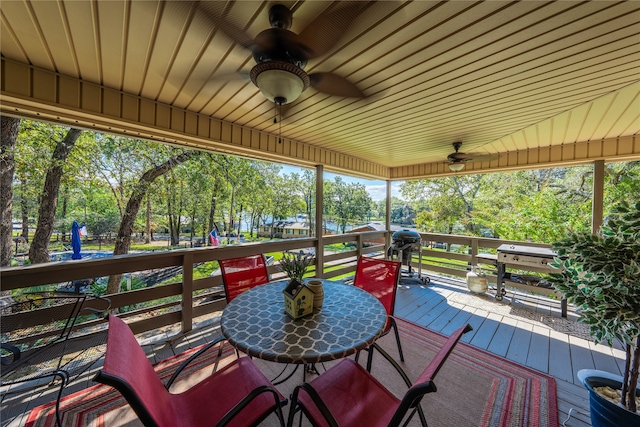 wooden terrace with grilling area and ceiling fan