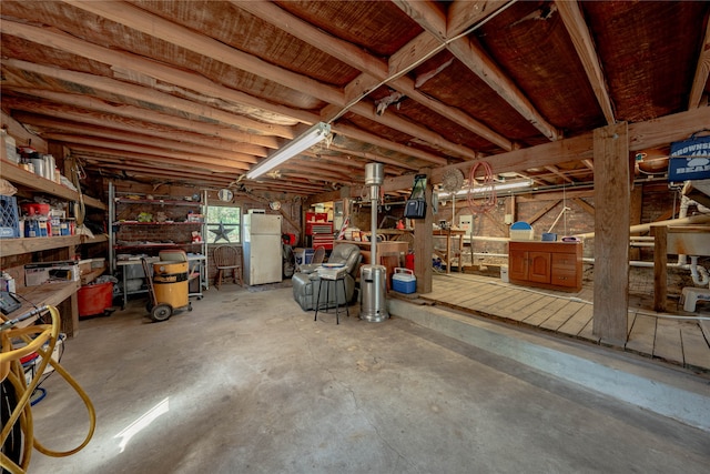 basement featuring white refrigerator