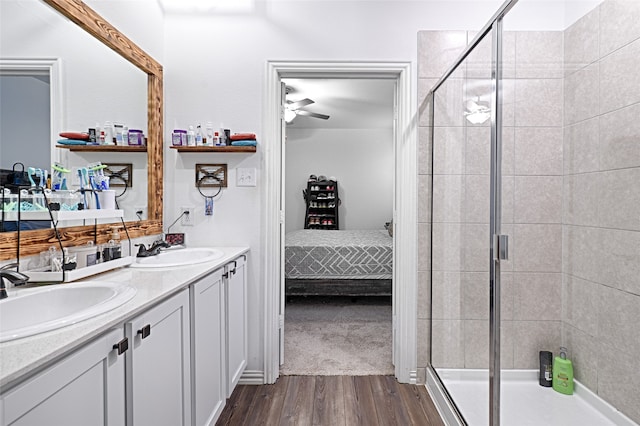 bathroom featuring vanity, ceiling fan, wood-type flooring, and an enclosed shower