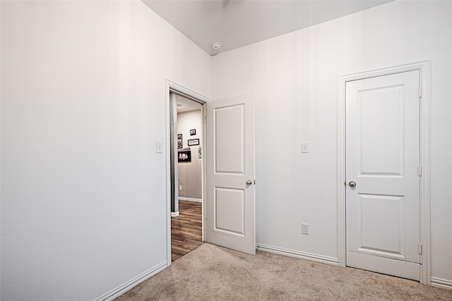 unfurnished room with light colored carpet