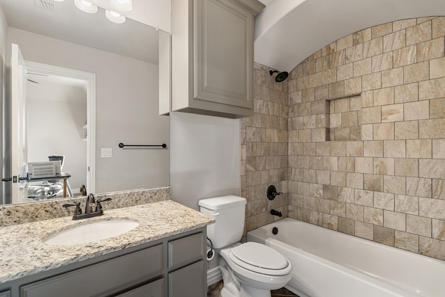 full bathroom with vanity, toilet, and tiled shower / bath combo