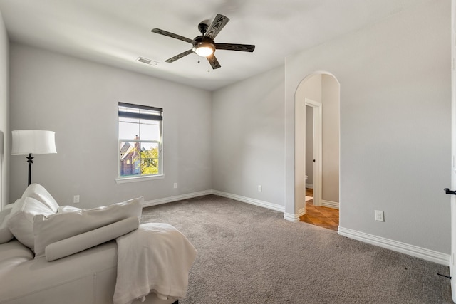 living area with ceiling fan and carpet floors