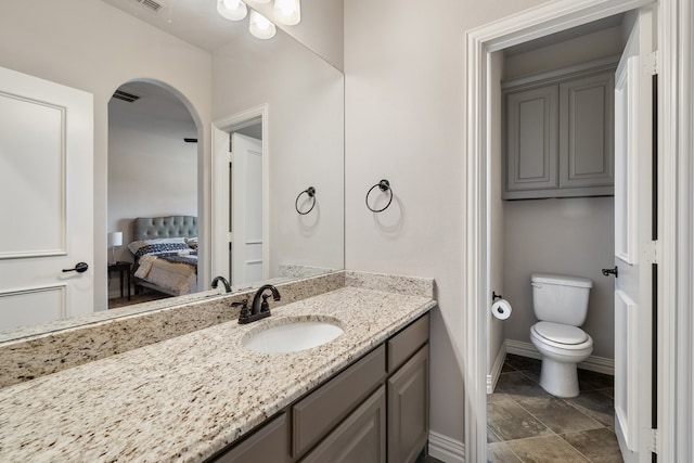 bathroom with vanity and toilet