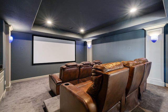 cinema featuring decorative columns, carpet floors, and a tray ceiling