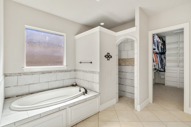 bathroom with tile patterned flooring and a tub