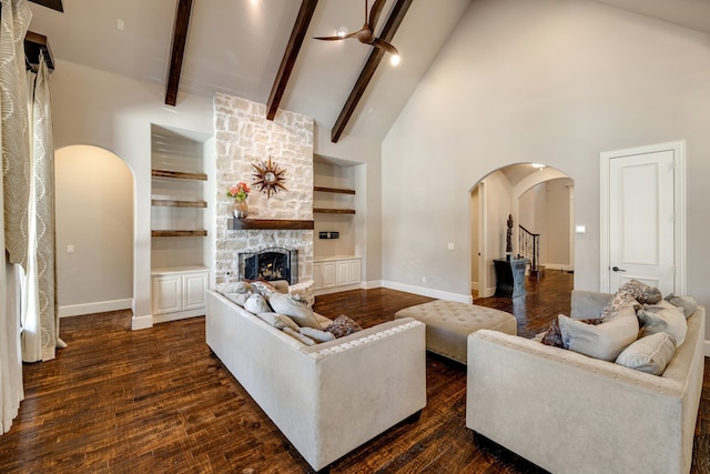 living room featuring built in features, a fireplace, beam ceiling, high vaulted ceiling, and dark hardwood / wood-style flooring