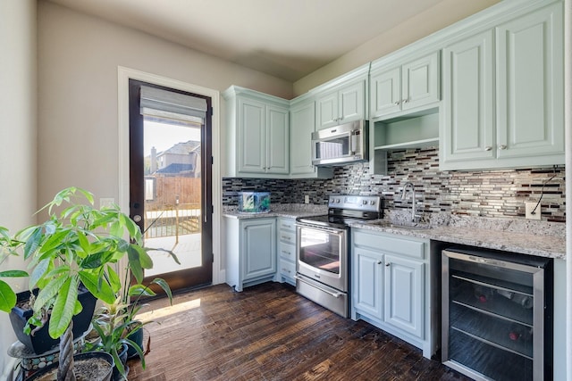 1240 Concho Trl, Prosper, TX 75078 - kitchen with beverage cooler, appliances with stainless steel finishes, backsplash, dark wood finished floors, and light stone countertops