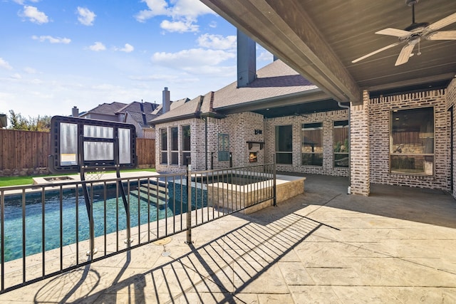 view of pool featuring ceiling fan and a patio